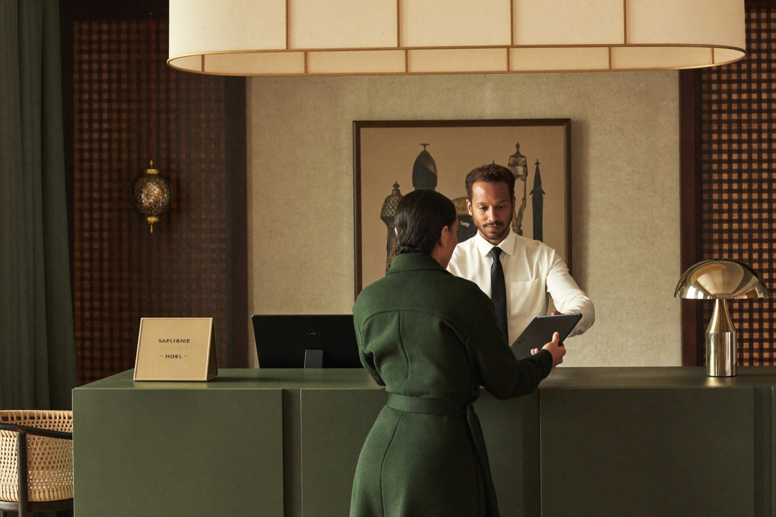 A hotel manager reviewing the portal at reception
